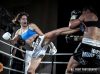 Claire Baxter kicking Leonie Macks at Rebellion MT XII by William Luu Fight Photography