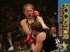 Sarah Kaufman punching Liz Carmouche at Strikeforce Challengers 17 by Josh Hedges
